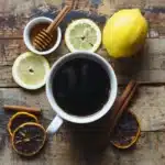 Tasty style image of black coffee served with lemon