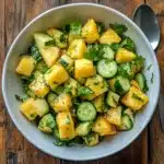 finished pineapple cucumber salad recipe in a white bowl
