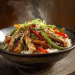 Served black pepper chicken with colorful stir-fried vegetables